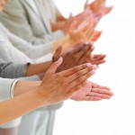 Closeup of business people clapping hands